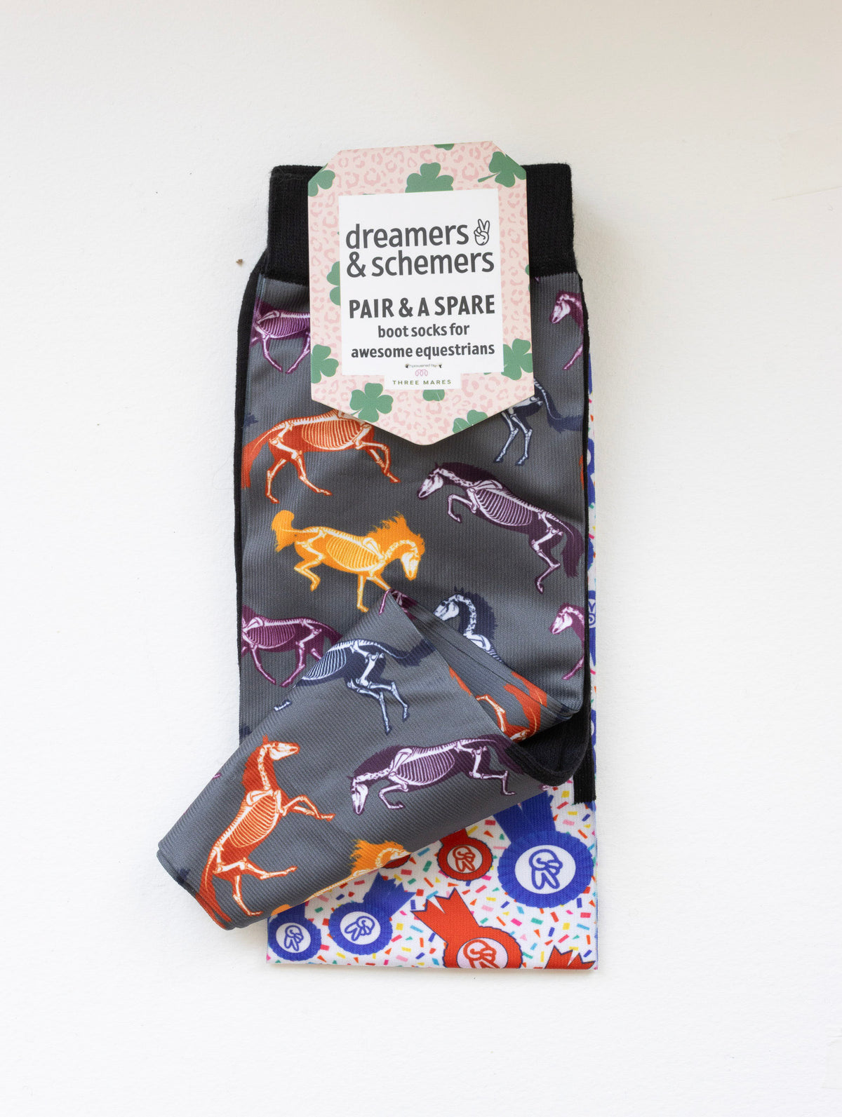 The Pony Island Horse Skeletons boot socks shown folded with the included spare sock and printed cuff detail
