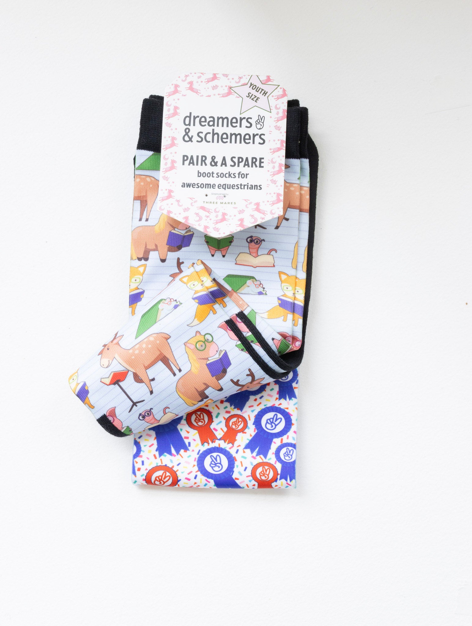 Bookworm youth boot socks shown folded with the included spare sock and patterned cuff