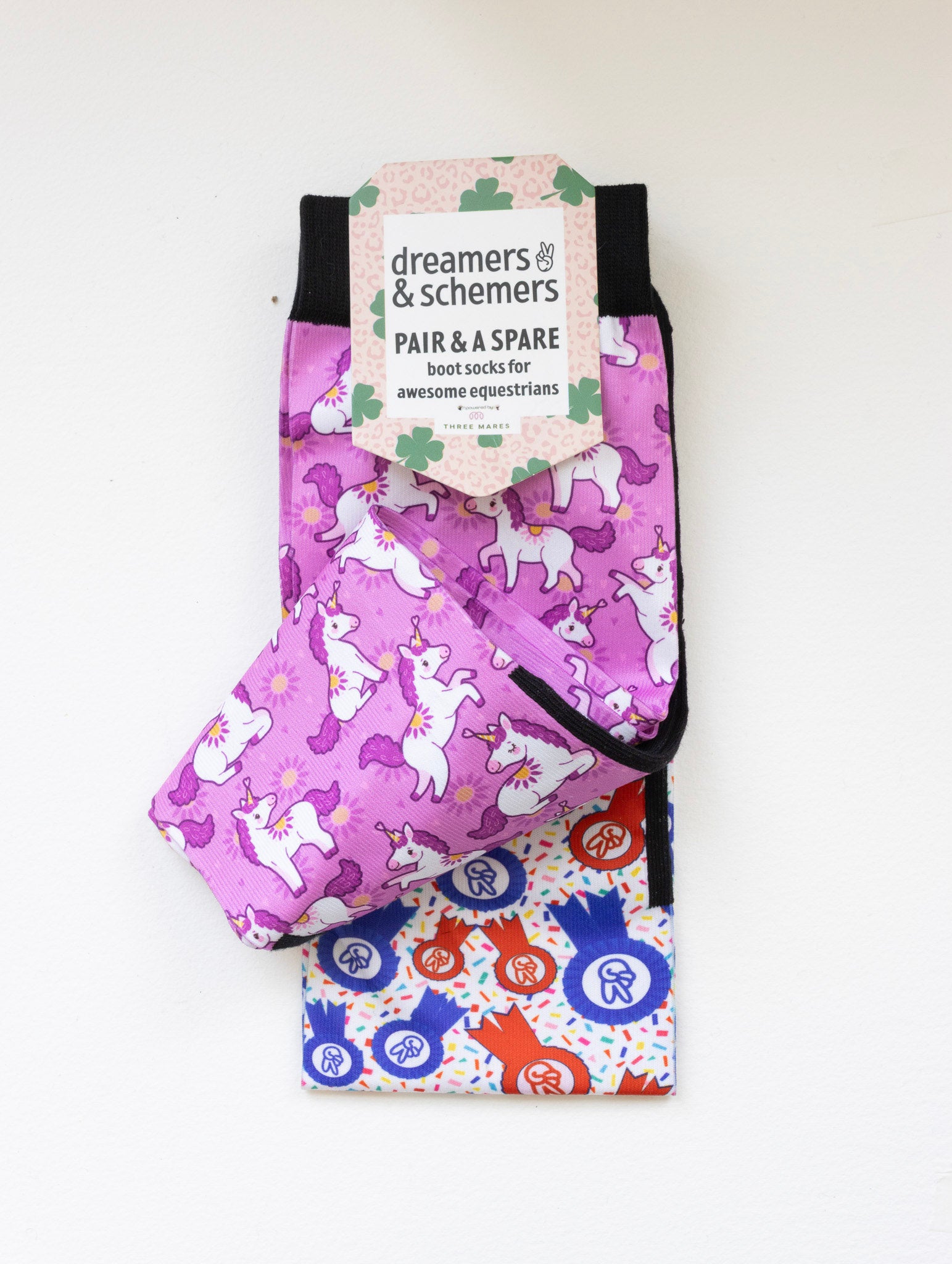 Sunshine and Unicorns boot socks shown folded with the included spare sock and printed cuff detail