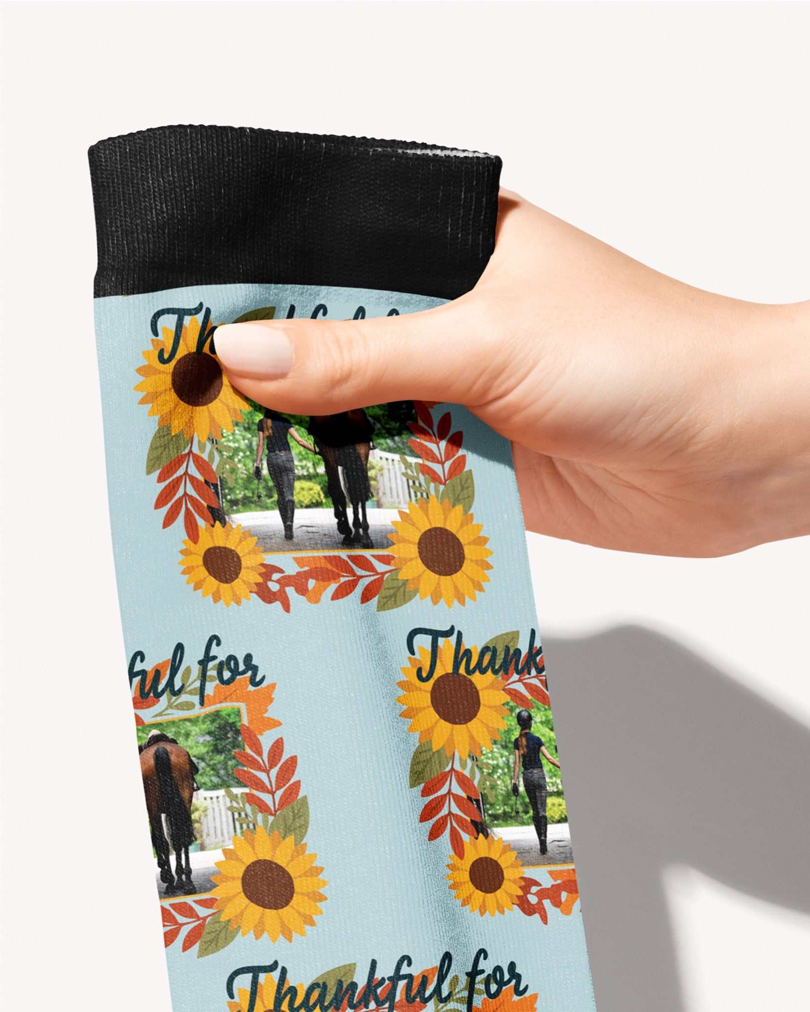 Thankful For custom photo equestrian boot socks, held in hand, close-up of the sunflower 'Thankful for' frame pattern, by Dreamers & Schemers