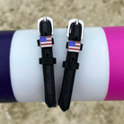 Black leather American flag spur straps draped over a colorful jump pole