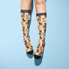 Aries zodiac themed boot socks in beige with black toes and ram illustrations, made in the USA