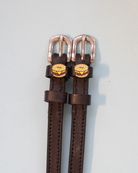 Dark brown leather bagel sandwich spur straps with rose-gold buckles