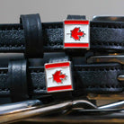 Close-up of Canadian maple-leaf flag charms on black leather ManeJane spur strap keepers