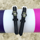 Cash money spur straps draped over a purple and pink jump pole outdoors
