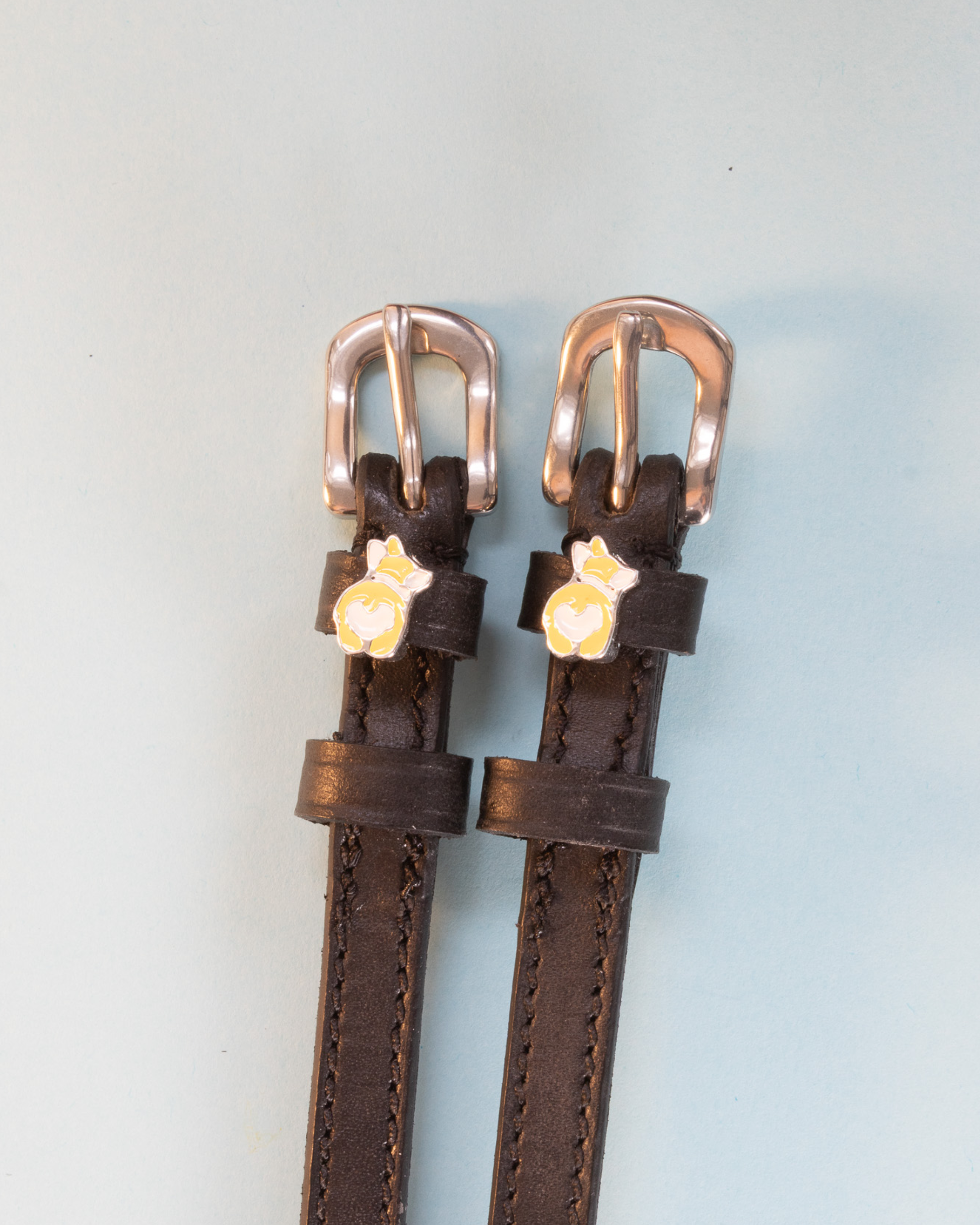 Dark brown leather corgi butt spur straps with rose-gold buckles