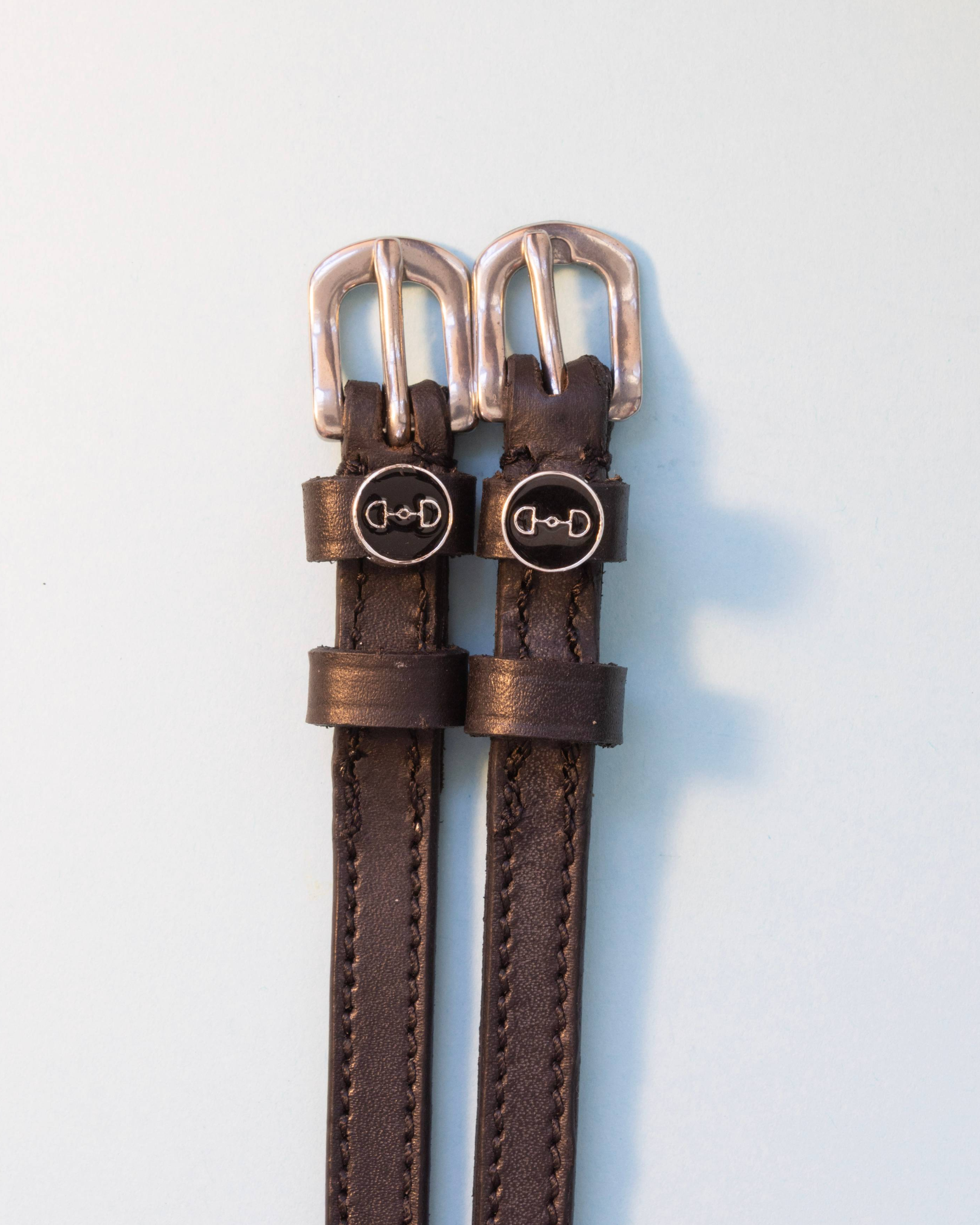 Brown leather ManeJane spur straps with black enamel snaffle-bit charms