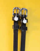 ManeJane Da Bird spur straps in black leather with white emoji charms on a bright yellow background