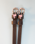 Brown leather ManeJane spur straps with pink flamingo charms and rose-gold buckles