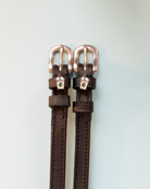 Dark brown leather spur straps with frappe cup charms and silver buckles