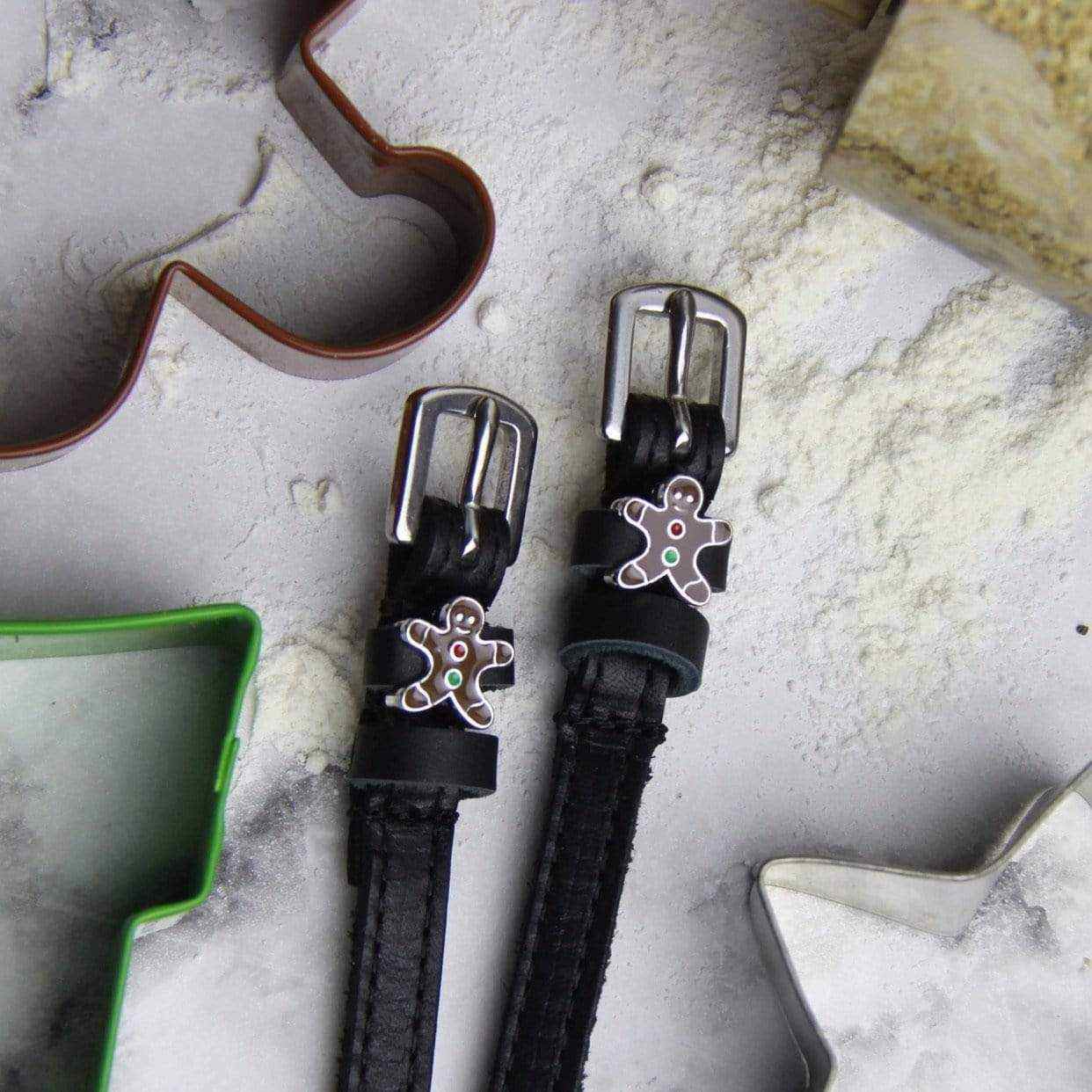 Gingerbread man spur straps on a floured board with festive cookie cutters