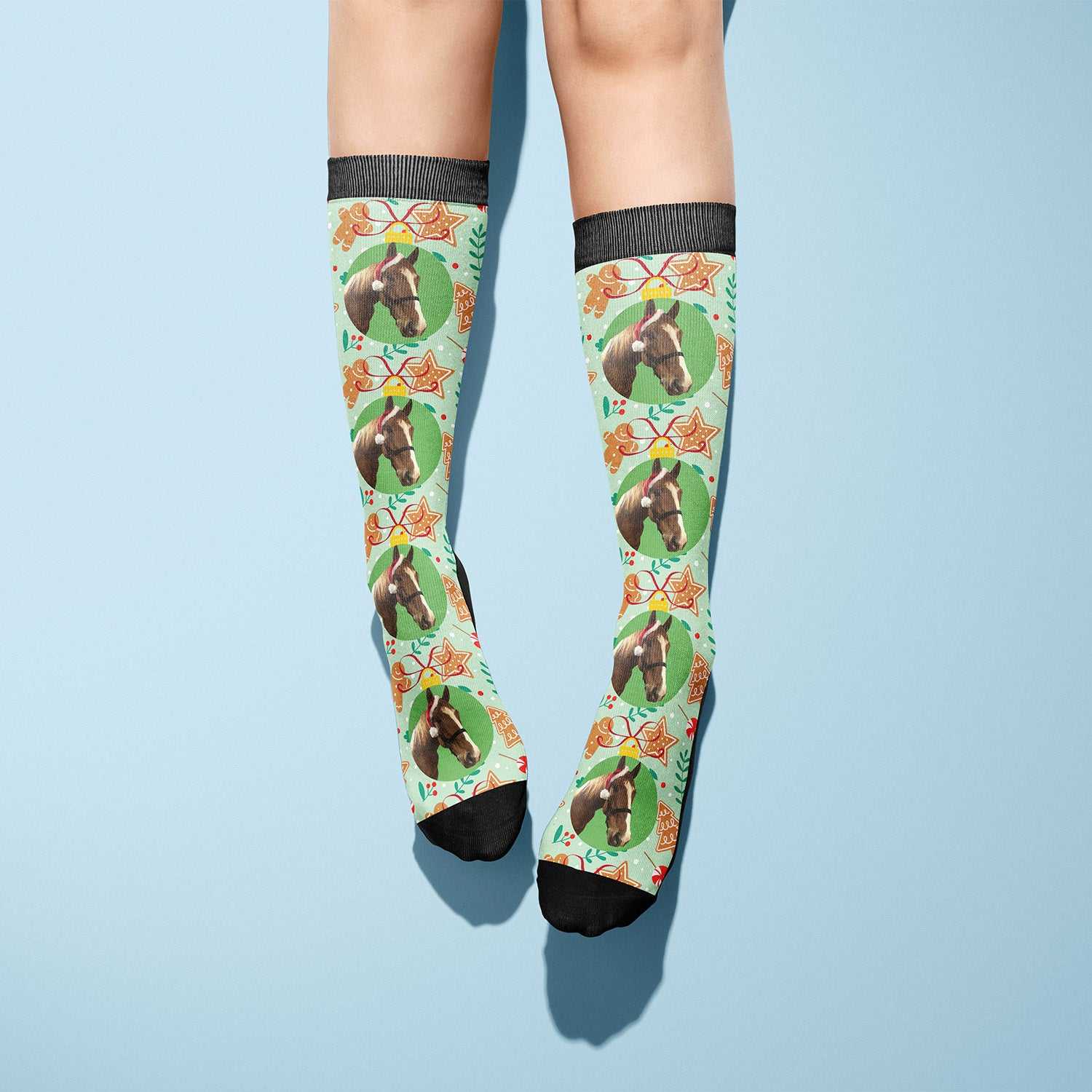 Custom socks with gingerbread cookie design and horse images on light blue background