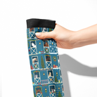 Limited Edition Pony Island Holiday Barn Socks with festive pony and holiday barn designs in blue, held by hand