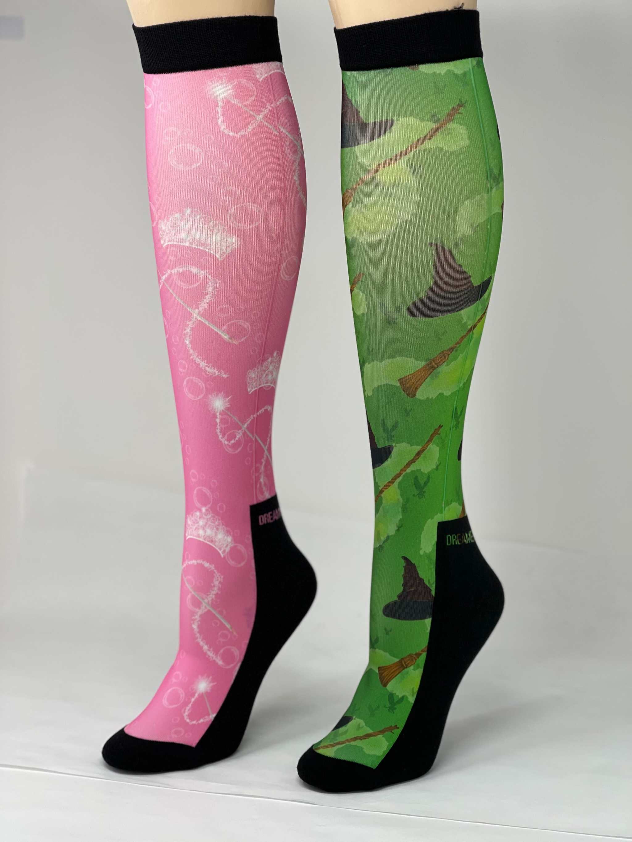 Pair of limited edition wicked boot socks in pink and green with unique magical designs