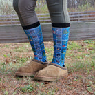 Limited Edition Pony Island Holiday Barn Socks with festive pony and barn designs worn with brown slippers outdoors