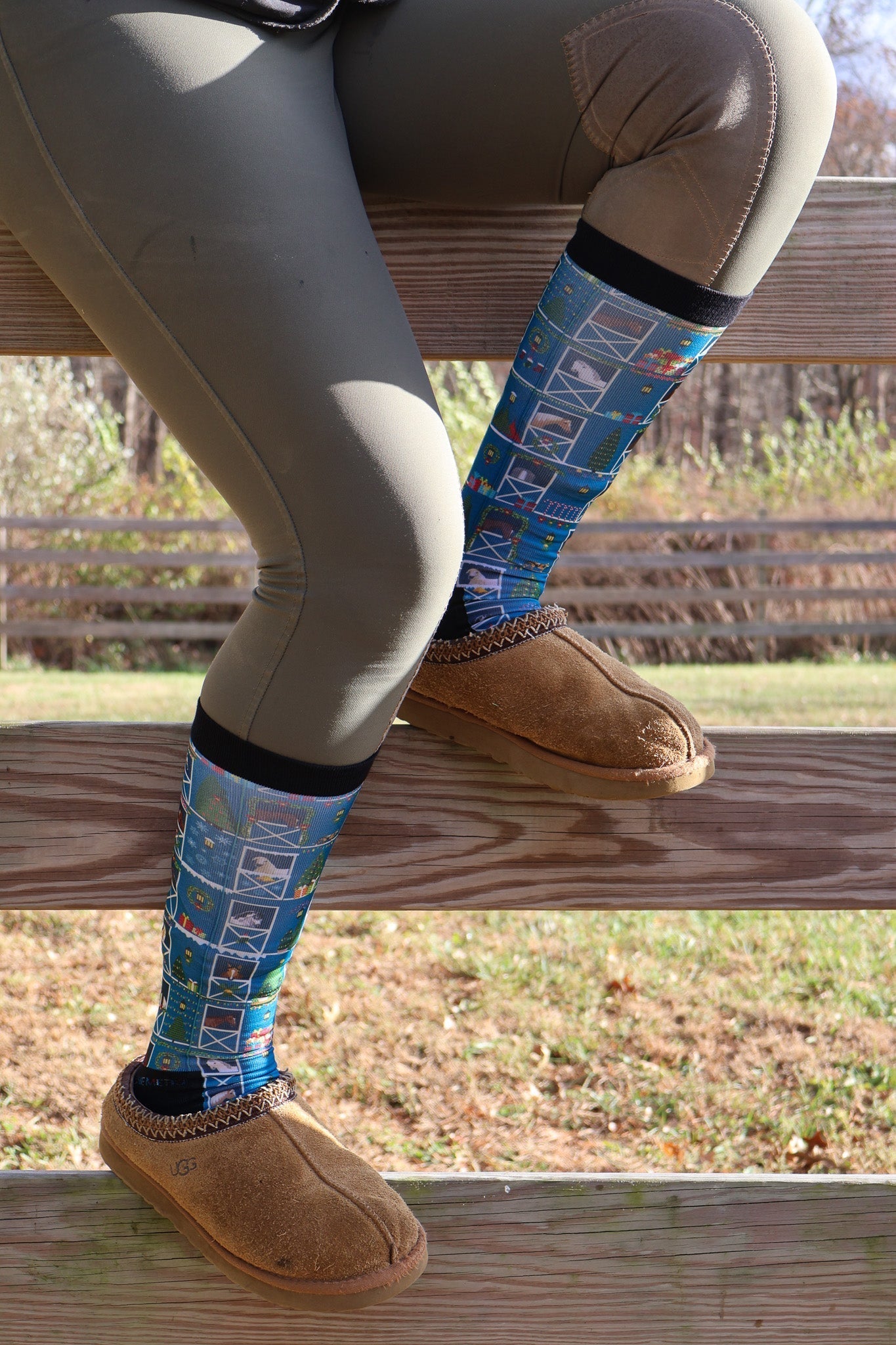 Limited Edition Pony Island Holiday Barn Socks with festive pony and garland design worn with slippers outdoors