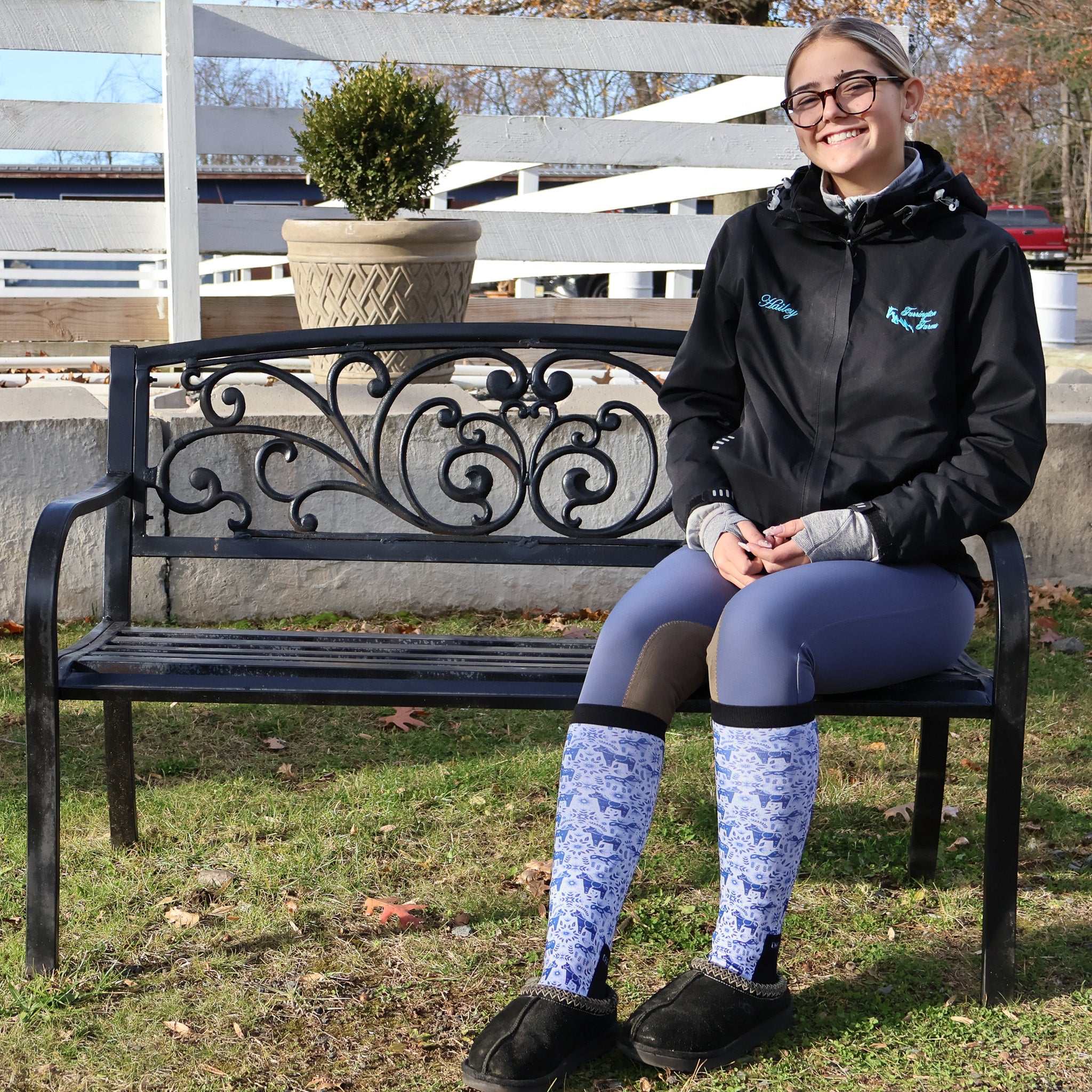 woman sitting on bench wearing Limited Edition Pony Island Dala Horses Socks with blue and white folk-art pony design