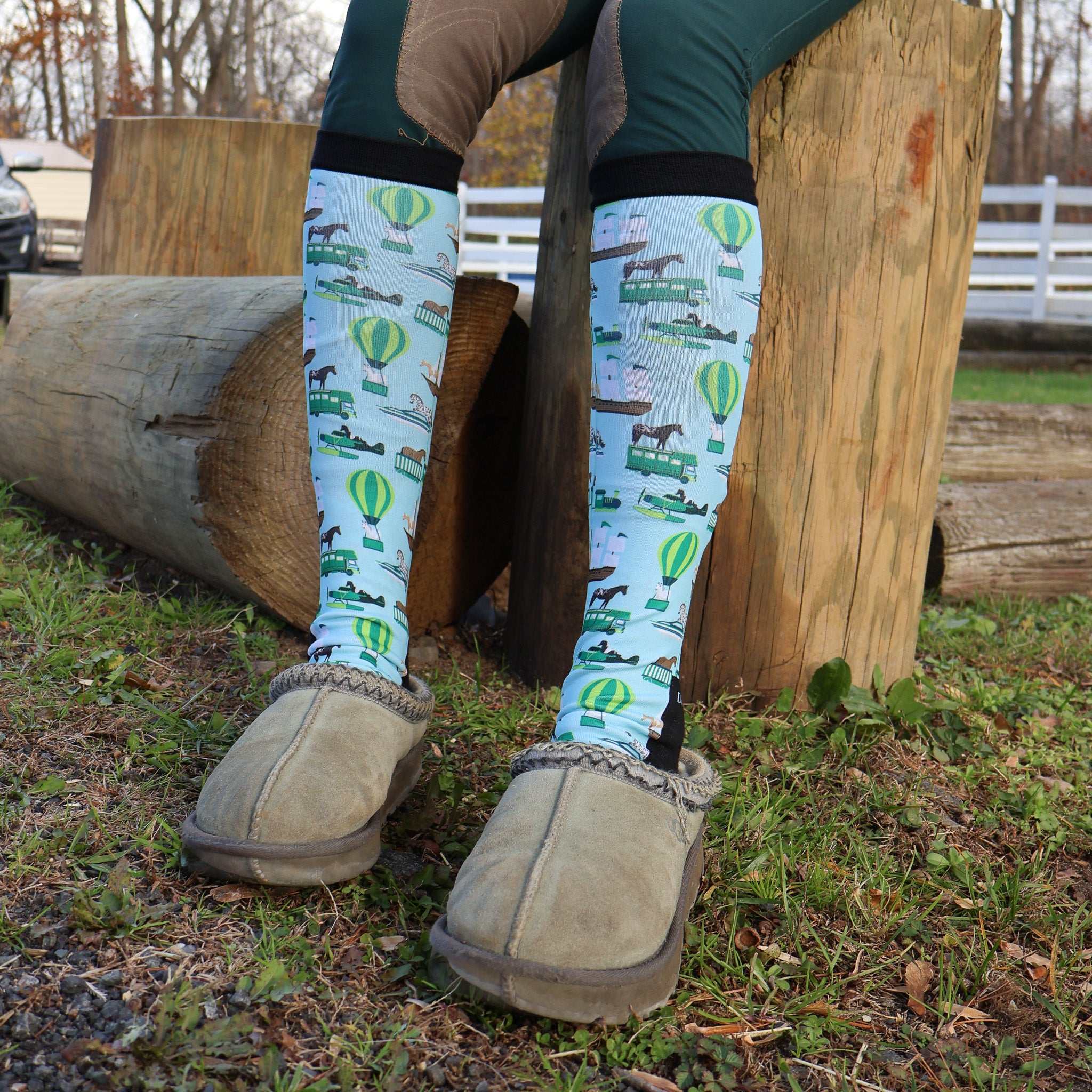 Limited Edition Pony Island Pony Transport Socks with pony and hot air balloon design on legs outdoors