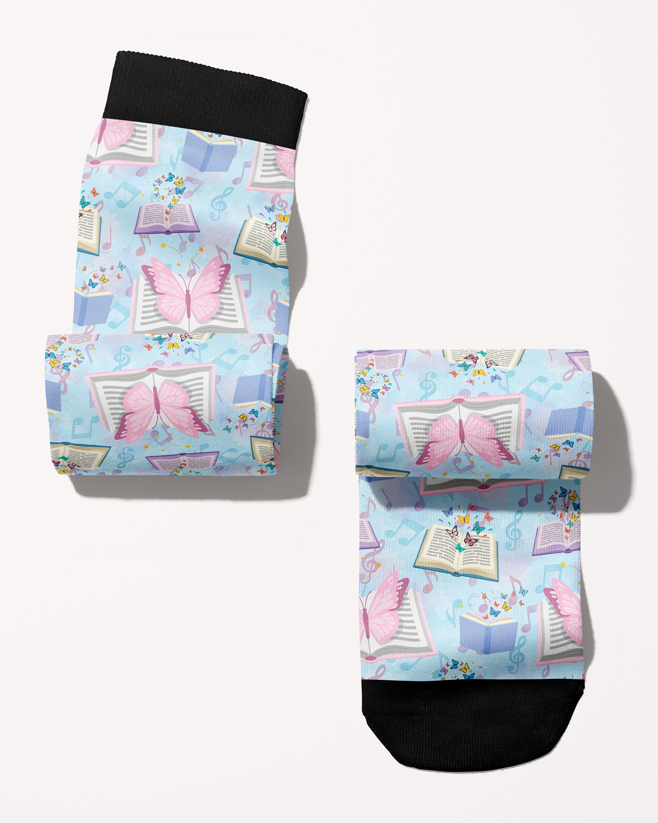 Reading 9-5 boot socks rolled into a pair, pastel blue with open books and butterflies