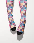 Socks of Many Colors socks shown on bare feet, black toes and heels against the patchwork print