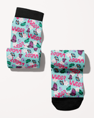 What Would Dolly Do? boot socks rolled into a pair, mint green with pink butterflies and flowers