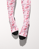 Dolly Forever socks shown on bare feet with black toes, pink cowgirl-themed print