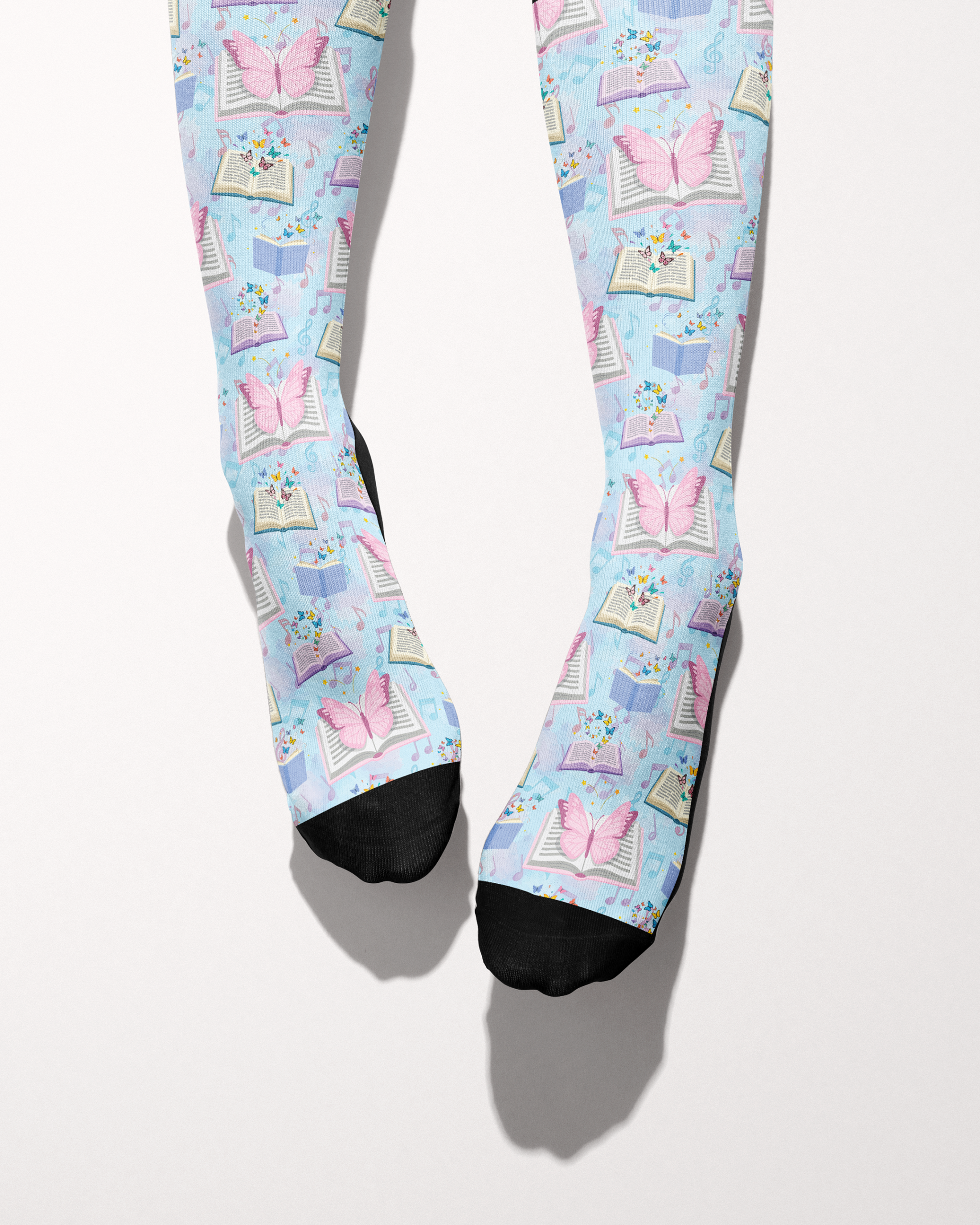 Reading 9-5 socks shown on bare feet, black toes against the books-and-butterflies print