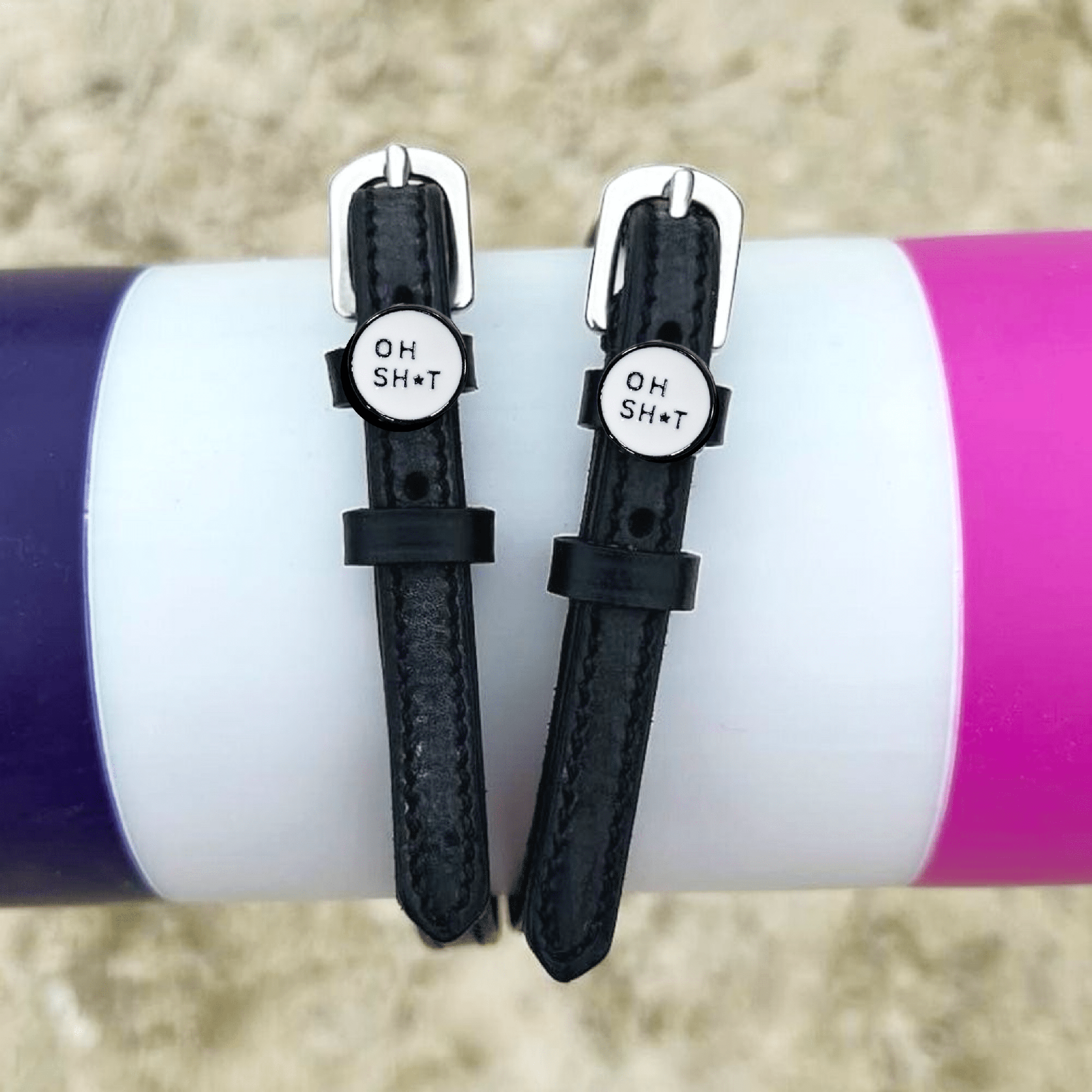 ManeJane OH SH*T spur straps wrapped around a colorful tumbler, lifestyle shot