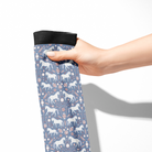 Limited Edition Pony Island Peppermint Ponies Socks with white ponies and candy cane pattern held in hand