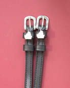 Silver unicorn head charm spur straps on black leather over a deep maroon background