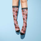 pink riding boot socks with horse pattern and black toes and cuffs