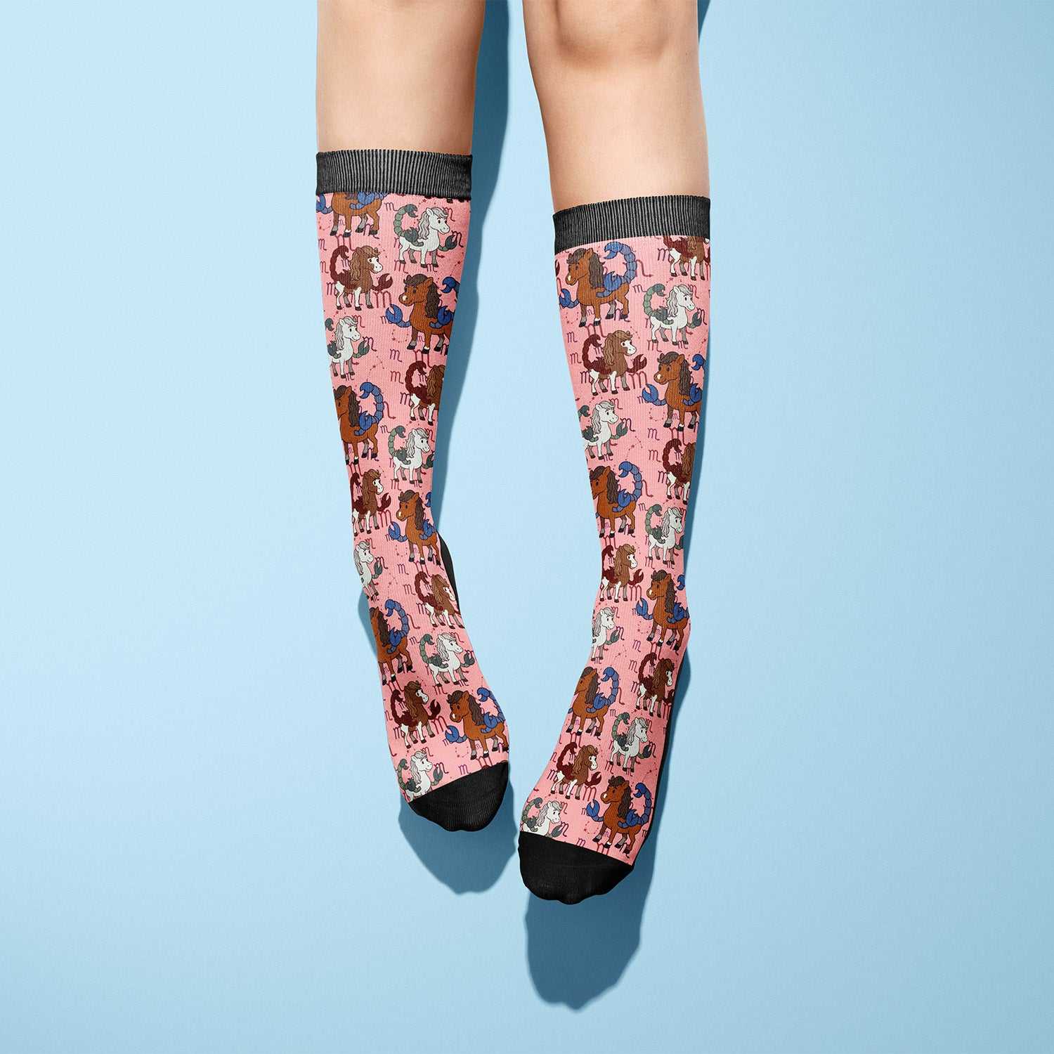 pink riding boot socks with horse pattern and black toes and cuffs