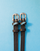 ManeJane stingray spur straps with pale blue ray charms on a light blue background
