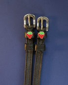 ManeJane strawberry spur straps with red-and-green strawberry charms on a navy background