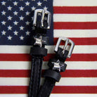 Black leather Boss star spur straps displayed on an American flag background