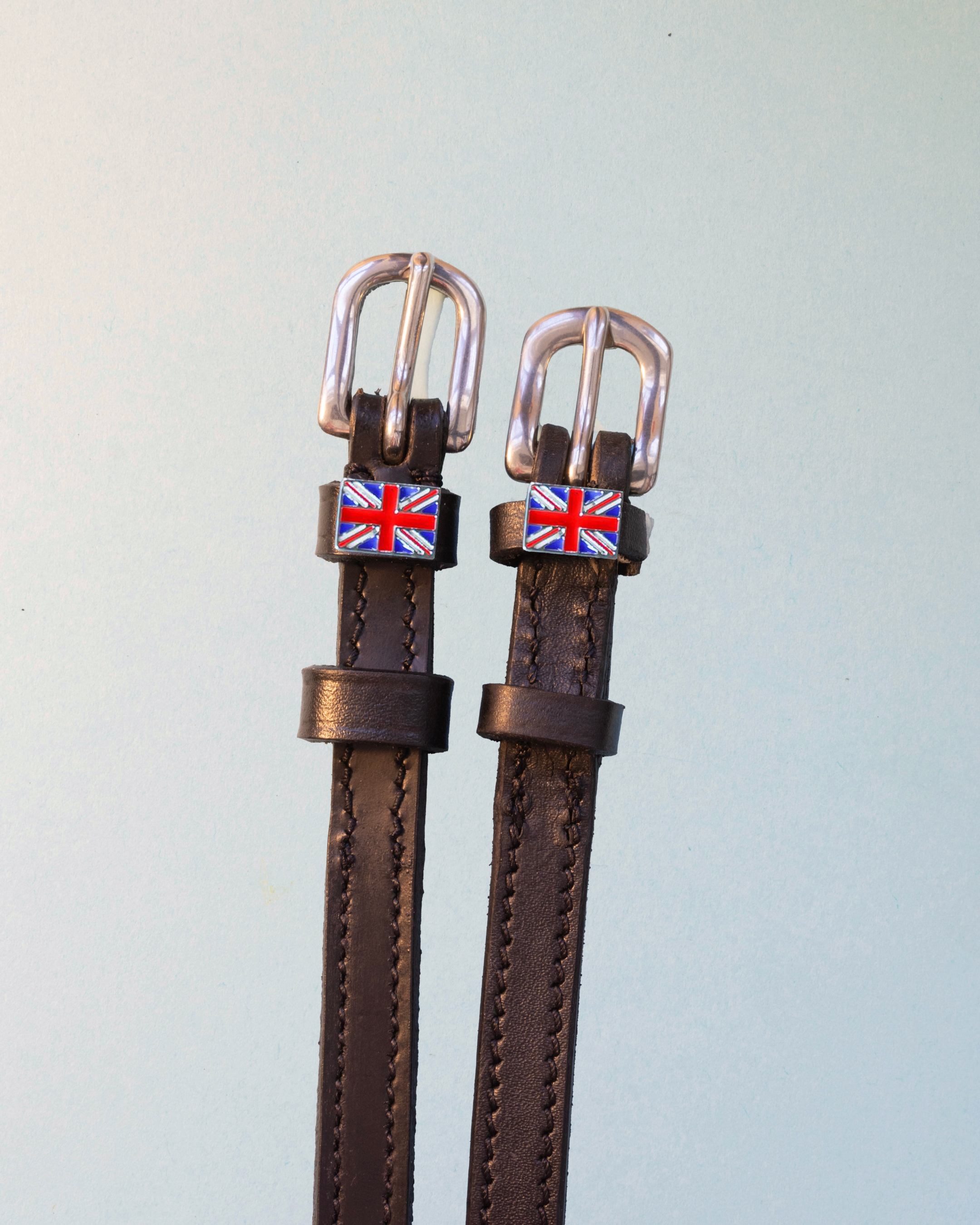 Brown leather ManeJane spur straps with enamel Union Jack flag charms on pale mint