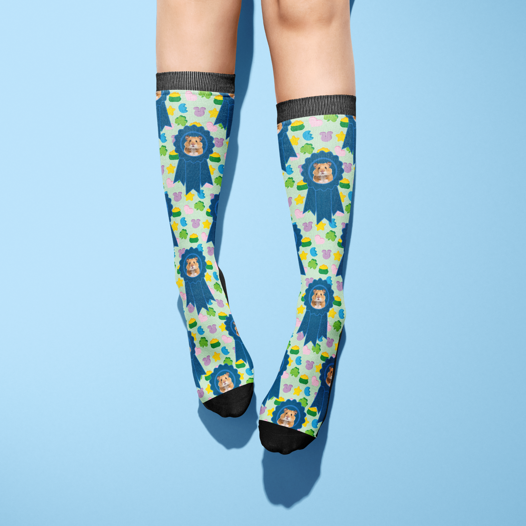 Custom blue ribbon socks with lucky treats pattern worn on legs against blue background
