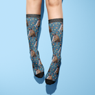 Custom Solo with Stable Snackies Socks featuring horse pattern on blue background worn on legs
