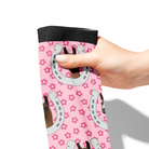 Hand holding pink socks with custom horseshoe and floral design pattern