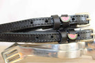 Brown leather ManeJane watermelon spur straps with rose-gold buckles on pale blue