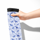 Limited Edition Pony Island Dala Horses socks with blue Scandinavian folk-art pony design, held by hand.