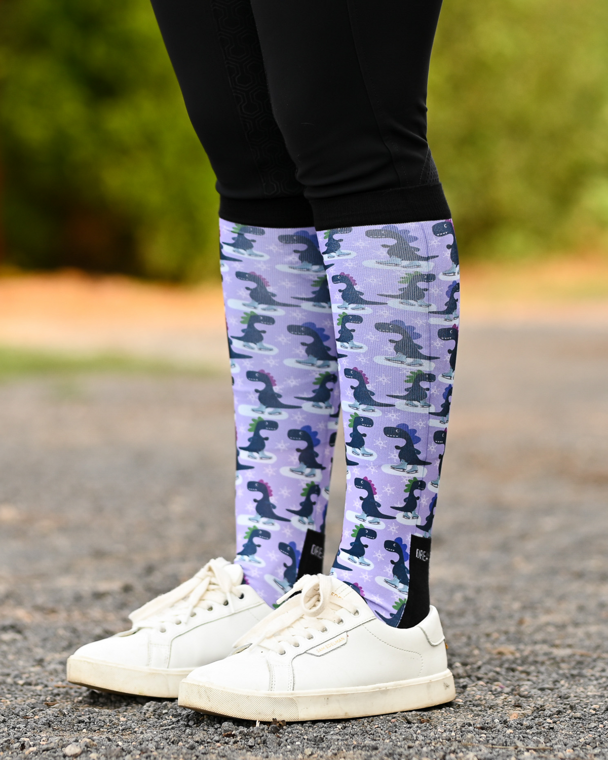 Dino-skate Pair & a Spare boot socks worn on the calf, lavender with dinosaurs skating on ice
