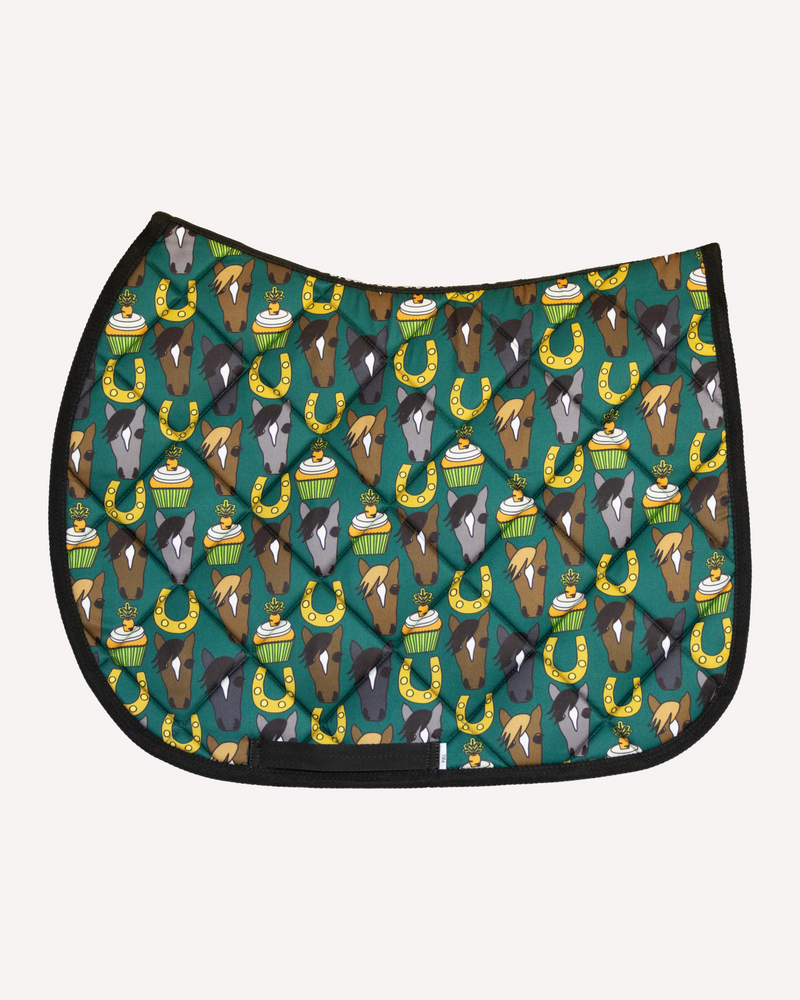 Carrot Cake saddle pad in teal with horse faces, cupcakes and horseshoes, English pad shown flat by Dreamers & Schemers
