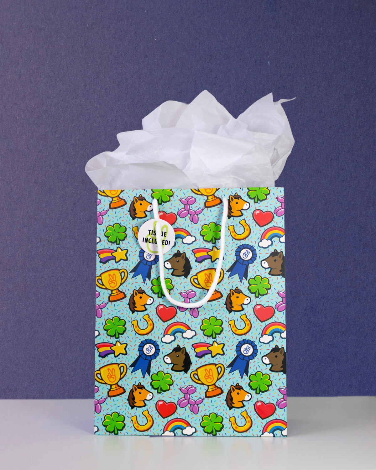 Full O' Luck medium gift bag front-on against navy, tissue paper puffed above the pale aqua print.