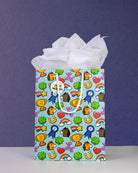 Full O' Luck medium gift bag front-on against navy, tissue paper puffed above the pale aqua print.