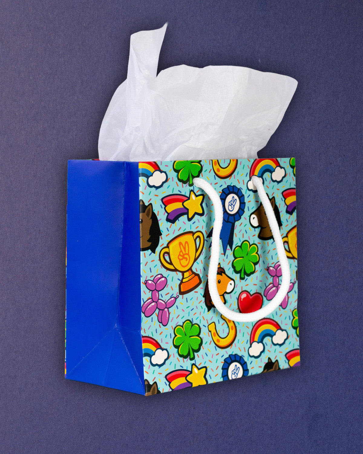 Full O' Luck small gift bag angled left, royal blue gusset beside the bright confetti-flecked print.