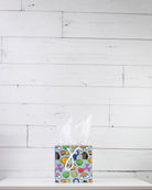 Full O' Luck small gift bag on a white shelf, aqua print of clovers, rainbows, horseshoes and hearts.