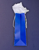 Full O' Luck medium gift bag laid on its side, royal blue gusset and folded base filling the frame.