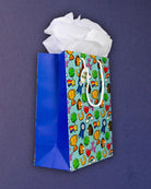 Full O' Luck medium gift bag at three-quarters, Tissue Included tag clear against the aqua print.
