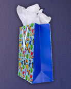 Full O' Luck medium gift bag turned steeply, the royal blue gusset taking the right half of the frame.